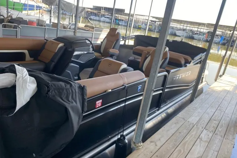 The Image of 2025 Premier Solaris 230RL pontoon boat docked, featuring luxurious seating and sleek design. - 0