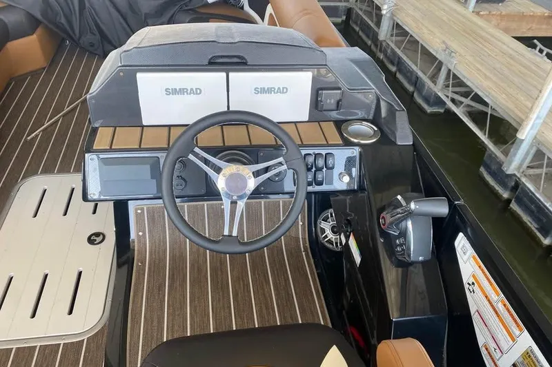 Slide: The Image of 2025 Premier Solaris 230RL boat dashboard with Simrad navigation system and modern controls. - 3