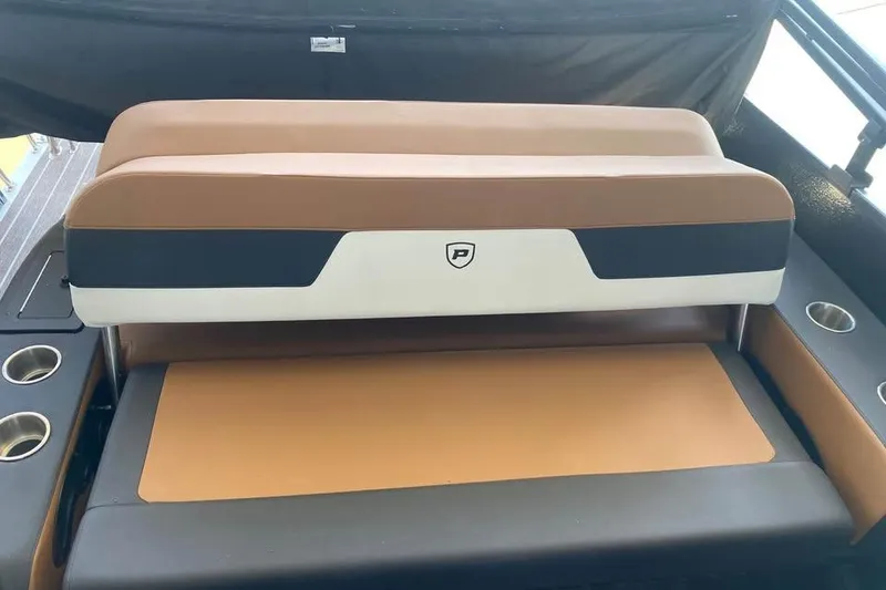 Slide: The Image of 2025 Premier Solaris 230RL boat seating with cup holders, featuring brown and black upholstery. - 5