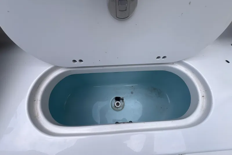 Slide: The Image of Livewell compartment on a 2024 Key West 203 FS boat, open lid view. - 22