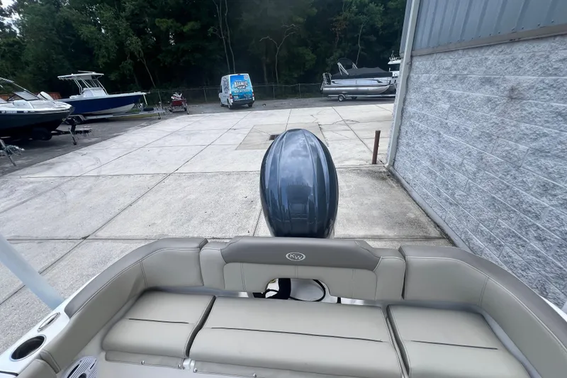 Slide: The Image of 2024 Key West 203 FS boat in a marina, featuring a sleek outboard motor. - 5