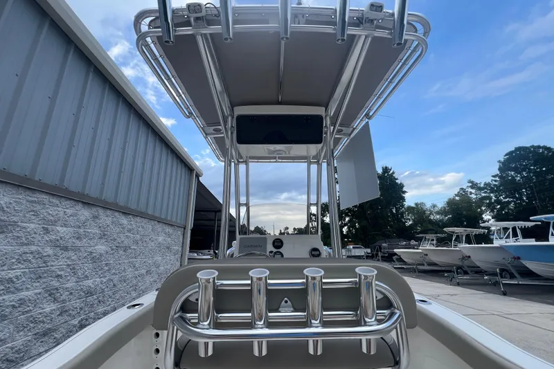 Slide: The Image of 2024 Key West 203 FS boat with T-top and rod holders, docked outdoors. - 7