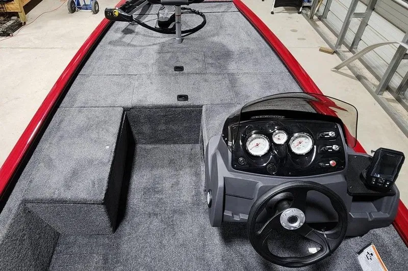Slide: The Image of 2026 Tracker Pro 170 boat interior with steering console and carpeted deck. - 3