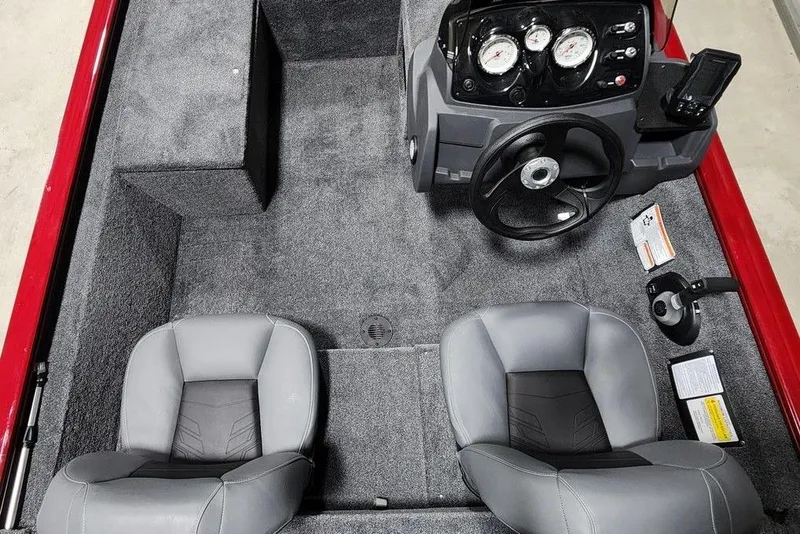 Slide: The Image of 2026 Tracker Pro 170 boat interior with steering console and two gray seats. - 7