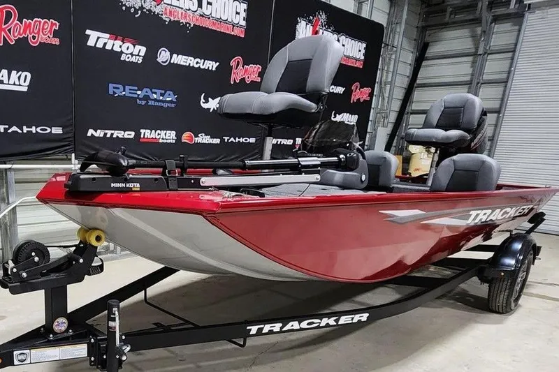 Slide: The Image of 2026 Tracker Pro 170 boat in showroom, red exterior, on trailer. - 9