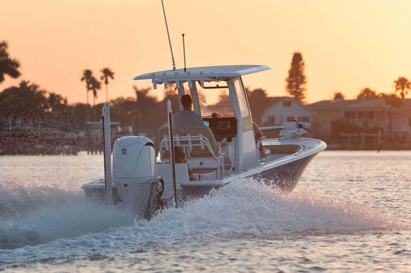 Slide: The Image of Manufacturer Provided Image: 2025 Sportsman Masters 247OE Bay Boat cruising at sunset on calm waters. - 1