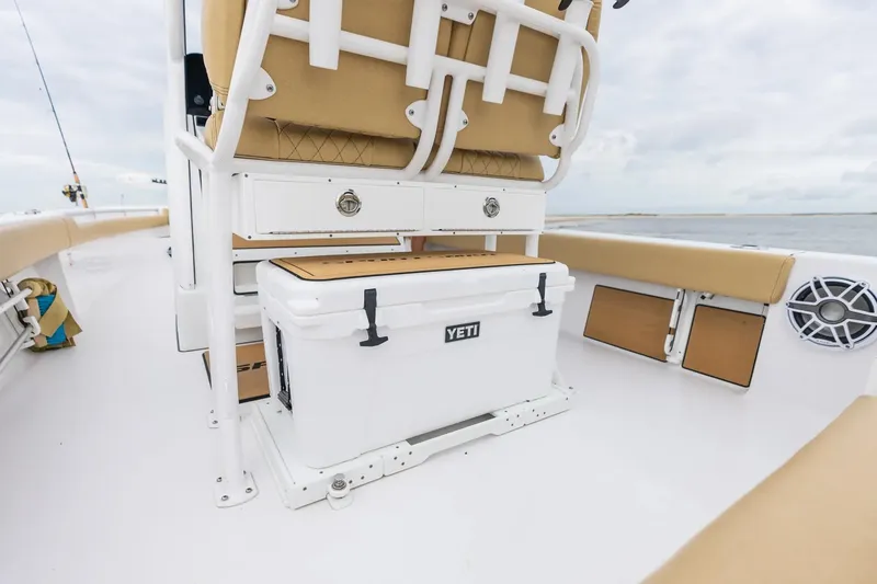 Slide: The Image of Manufacturer Provided Image: 2025 Sportsman Masters 247OE Bay Boat interior with Yeti cooler and tan seating. - 10