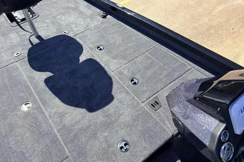 Slide: The Image of 2026 Ranger RT198P boat deck with gray carpet and seat shadow. - 17