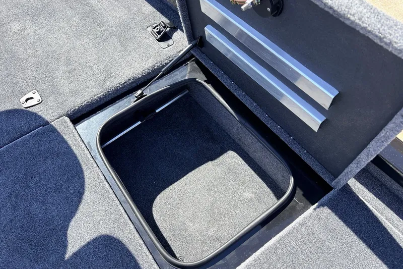Slide: The Image of Open storage compartment in 2026 Ranger RT198P boat with carpeted interior. - 23