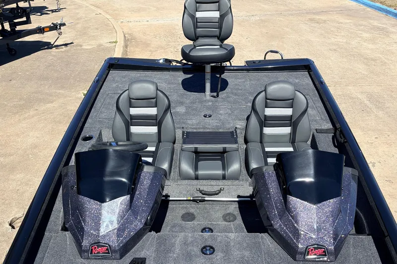 Slide: The Image of 2026 Ranger RT198P boat interior with three gray seats and dual consoles. - 29