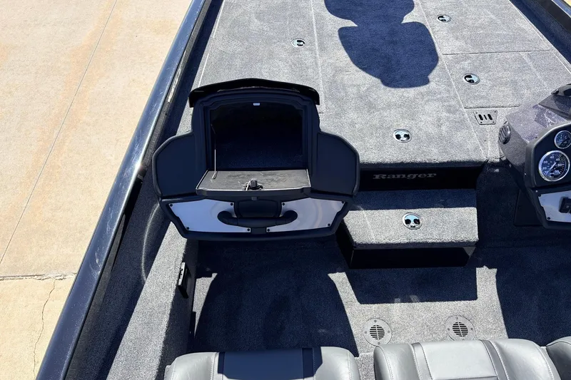 Slide: The Image of 2026 Ranger RT198P boat interior with open storage compartment and dashboard view. - 33