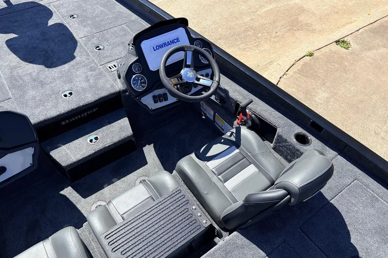 Slide: The Image of 2026 Ranger RT198P boat interior with steering wheel and seating, featuring Lowrance electronics. - 34