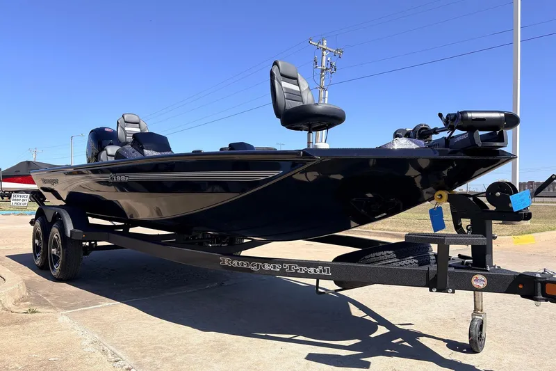 Slide: The Image of 2026 Ranger RT198P boat on trailer, sleek design, parked outdoors under clear blue sky. - 4