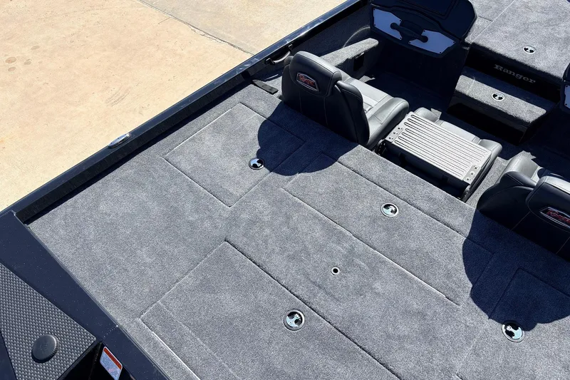 Slide: The Image of 2026 Ranger RT198P boat interior with spacious carpeted deck and seating. - 40