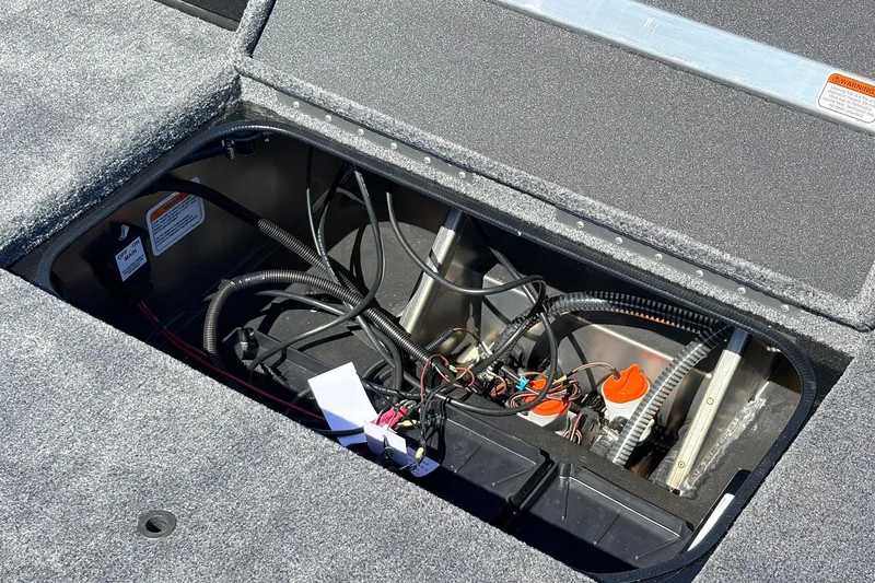 Slide: The Image of Open compartment of 2026 Ranger RT198P boat showing wiring and components. - 46