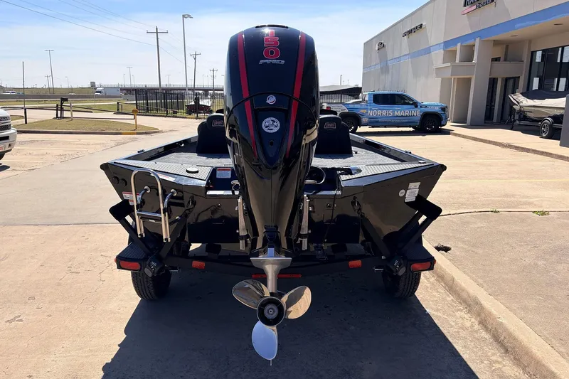 Slide: The Image of 2026 Ranger RT198P boat with powerful outboard motor, parked at a marina dealership. - 8