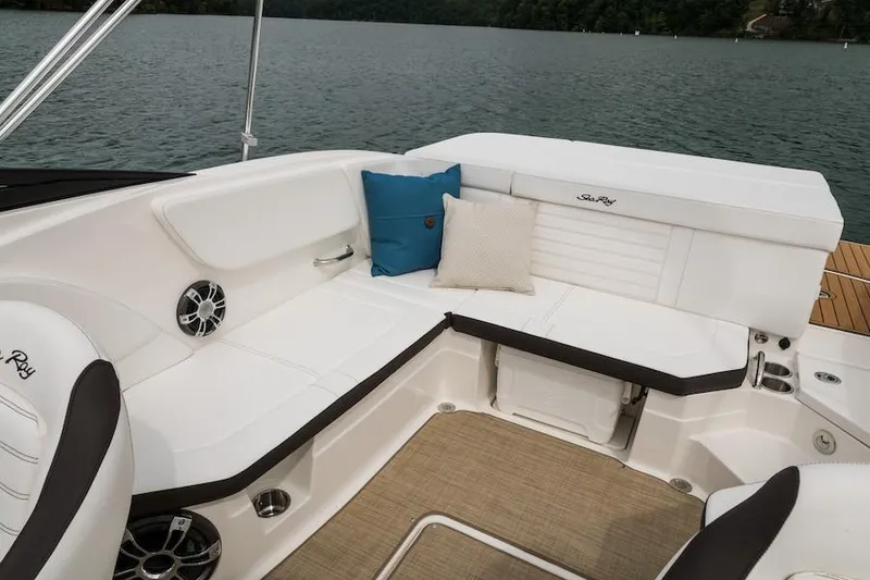 Slide: The Image of Manufacturer Provided Image: 2021 Sea Ray SPX 230 boat interior with white seating and lake view. - 10