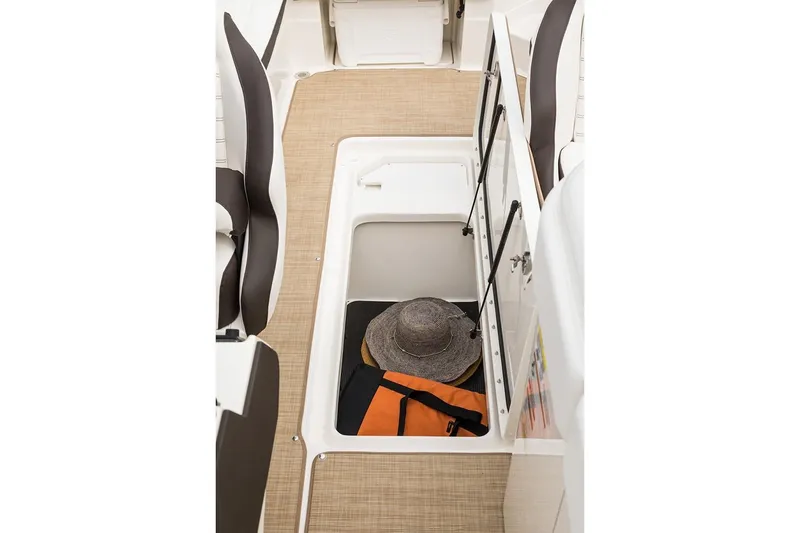 Slide: The Image of Manufacturer Provided Image: 2021 Sea Ray SPX 230 storage compartment with life jacket and hat. - 12