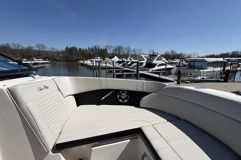 Slide: The Image of 2021 Sea Ray SPX 230 boat interior at marina with other boats docked. - 20