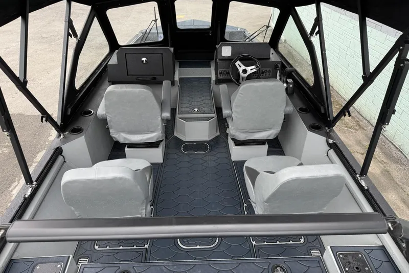Slide: The Image of Interior of 2026 SeaArk Dynasty 2.0 boat with four seats and steering console. - 11