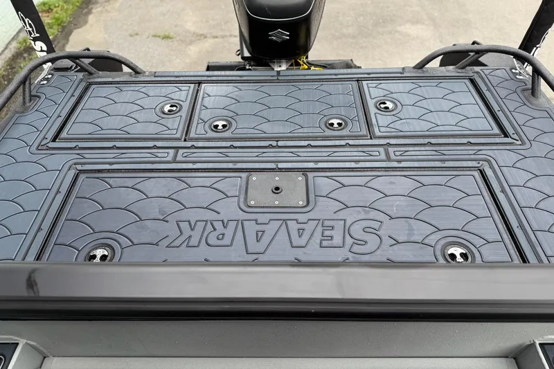 Slide: The Image of 2026 SeaArk Dynasty 2.0 boat deck with textured surface and storage compartments. - 12