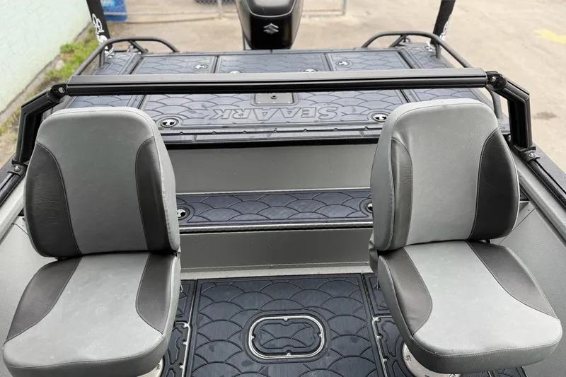 Slide: The Image of 2026 SeaArk Dynasty 2.0 boat interior with two gray seats and textured flooring. - 13