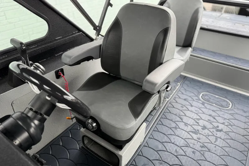 Slide: The Image of Interior of 2026 SeaArk Dynasty 2.0 boat with steering wheel and seating. - 17