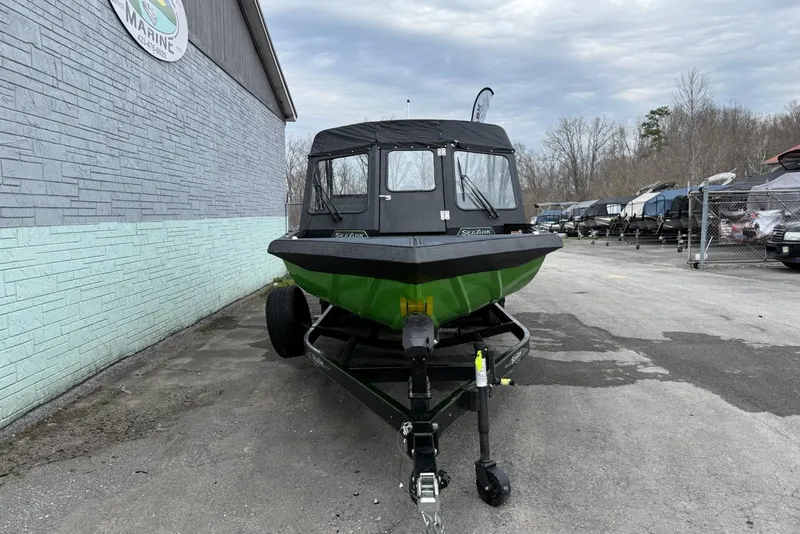 Slide: The Image of 2026 SeaArk Dynasty 2.0 boat on trailer, parked outside a marine dealership. - 4