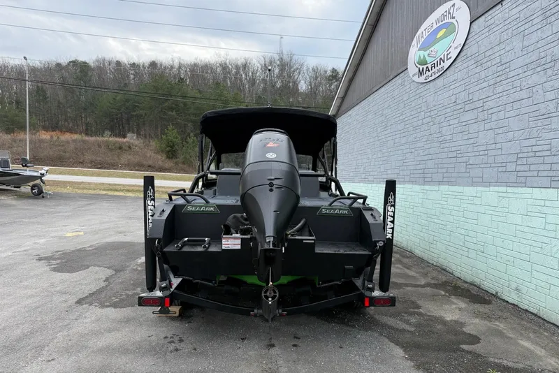 Slide: The Image of 2026 SeaArk Dynasty 2.0 boat, rear view, parked outside Water Workz Marine. - 7