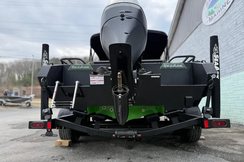 Slide: The Image of 2026 SeaArk Dynasty 2.0 boat rear view with motor and trailer. - 8
