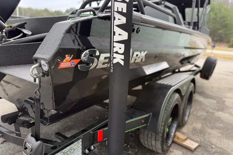 Slide: The Image of 2026 SeaArk Dynasty 2.0 boat on trailer, showcasing sleek black design and branding. - 9
