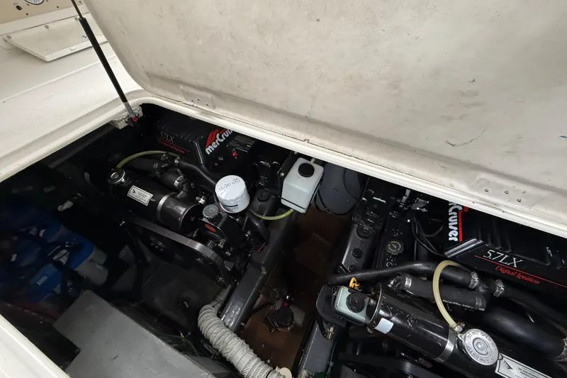 Slide: The Image of Engine compartment of a 1997 Larson Cabrio 310 Mid-Cabin boat with MerCruiser engines. - 10