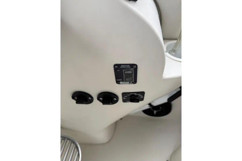 Slide: The Image of Control panel of 1997 Larson Cabrio 310 Mid-Cabin boat, featuring switches and dials. - 12