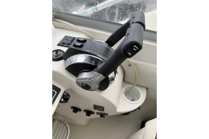 Slide: The Image of Close-up of throttle controls on a 1997 Larson Cabrio 310 Mid-Cabin boat. - 14