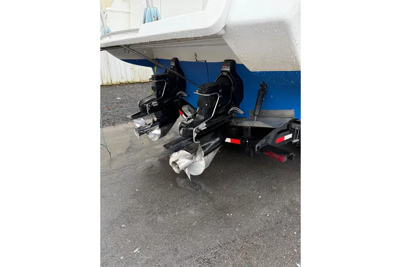 Slide: The Image of 1997 Larson Cabrio 310 Mid-Cabin boat with dual propellers on a trailer. - 4