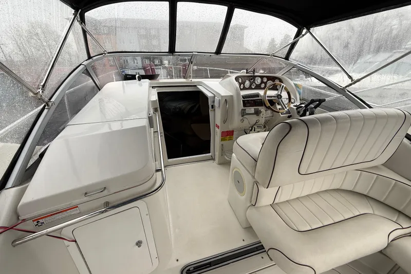 Slide: The Image of 1997 Larson Cabrio 310 Mid-Cabin boat interior with helm and seating area. - 7