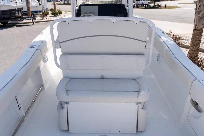 Slide: The Image of 2023 Sea Hunt Ultra 239 SE boat interior with white cushioned seating. - 12