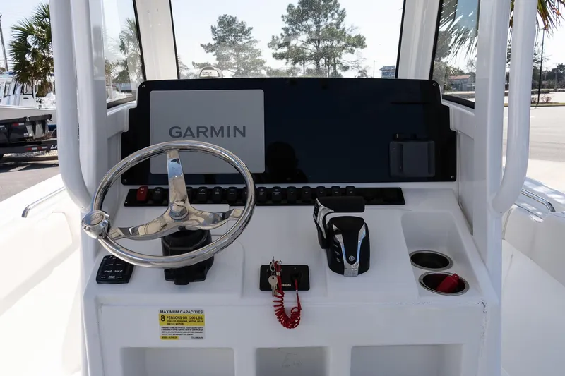 Slide: The Image of 2023 Sea Hunt Ultra 239 SE boat console with Garmin navigation system and steering wheel. - 13