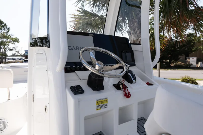 Slide: The Image of 2023 Sea Hunt Ultra 239 SE boat console with steering wheel and Garmin display. - 14