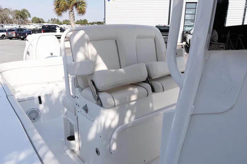 Slide: The Image of 2023 Sea Hunt Ultra 239 SE boat interior with white cushioned seating. - 16