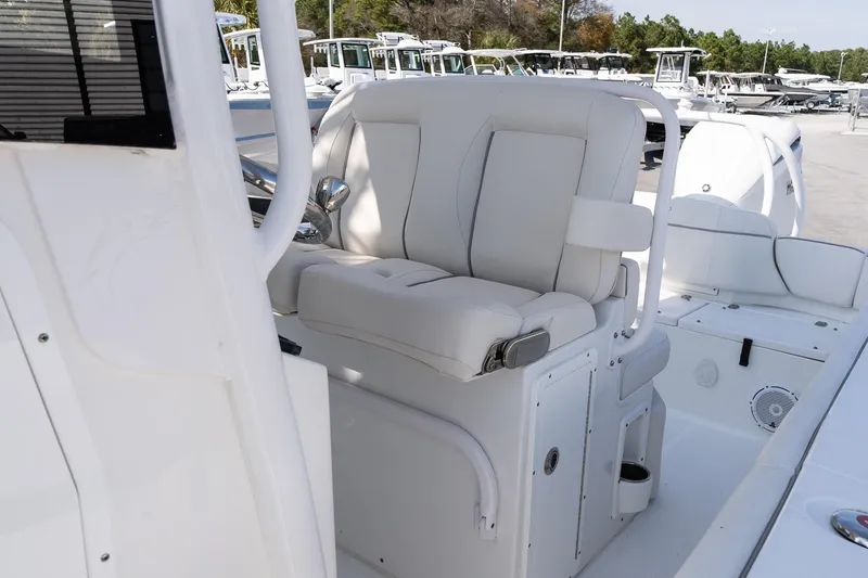 Slide: The Image of 2023 Sea Hunt Ultra 239 SE boat interior with white seating and console. - 17