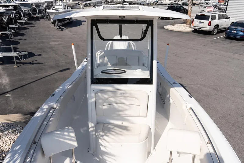 Slide: The Image of 2023 Sea Hunt Ultra 239 SE boat, white interior, parked in a dealership lot. - 20