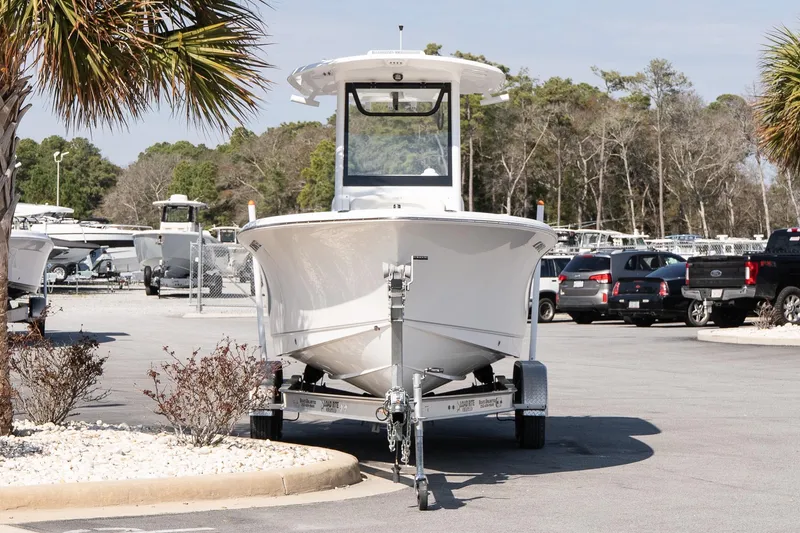 Slide: The Image of 2023 Sea Hunt Ultra 239 SE boat on trailer in parking lot. - 3