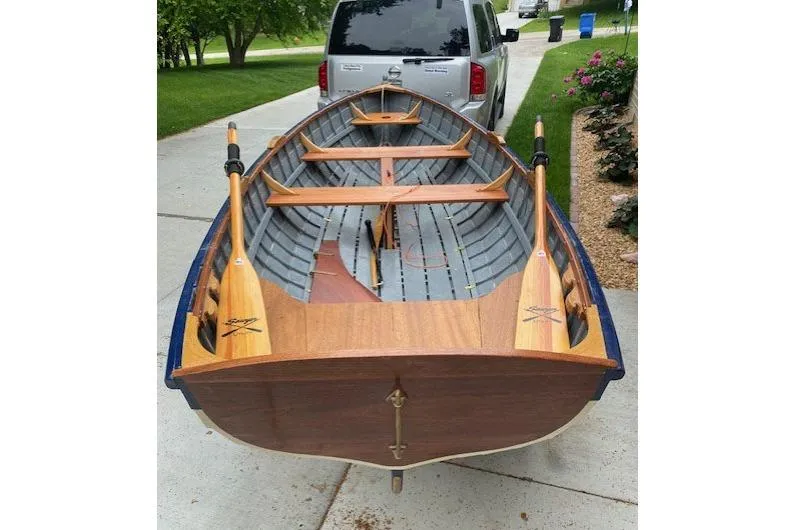 Slide: The Image of Handcrafted 2019 "Cat's Paw" wooden boat on driveway, showcasing detailed craftsmanship. - 13