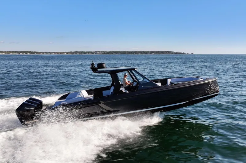 Slide: The Image of 2024 Vanquish Yachts 40 speeding on open water, showcasing sleek design and powerful performance. - 13