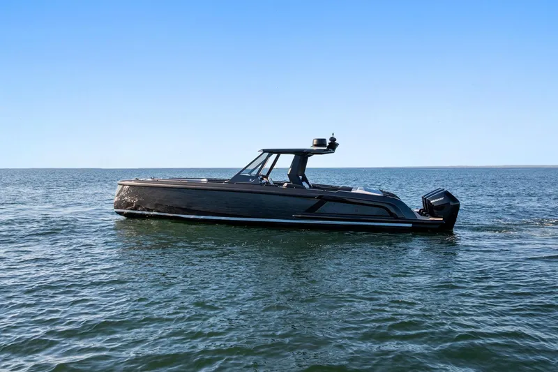 Slide: The Image of 2024 Vanquish Yachts 40 cruising on open water under clear blue skies. - 15