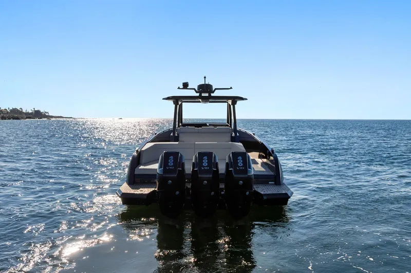 Slide: The Image of 2024 Vanquish Yachts 40 on open water, rear view with triple engines. - 17