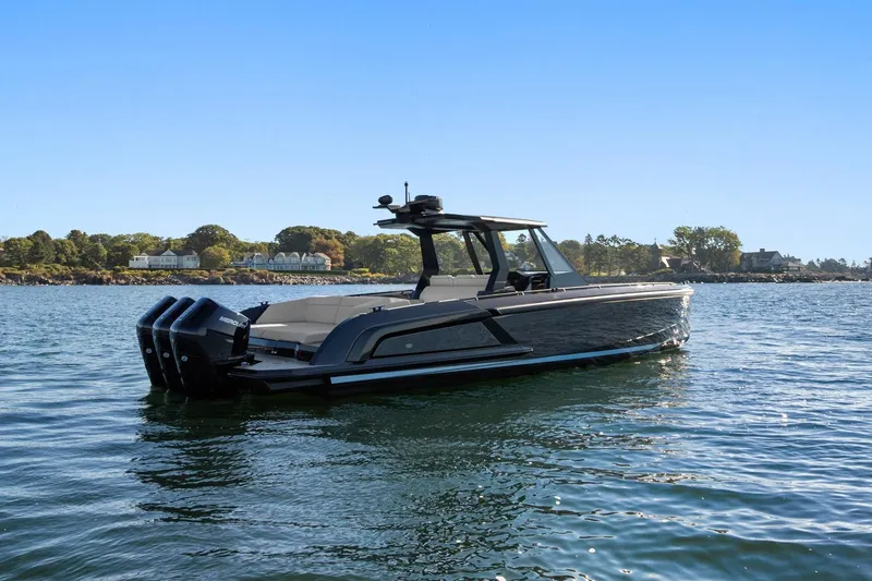 Slide: The Image of 2024 Vanquish Yachts 40 on serene water, showcasing sleek design and powerful engines. - 18