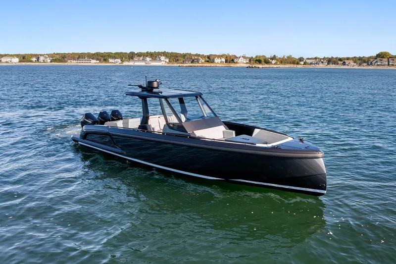 Slide: The Image of 2024 Vanquish Yachts 40 cruising on calm waters under a clear blue sky. - 20