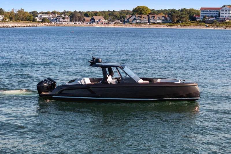 Slide: The Image of 2024 Vanquish Yachts 40 cruising on a serene coastal waterway. - 24